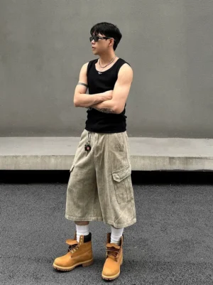 Stonewashed khaki corduroy baggy cargo long shorts left side view with oversized flap utility pocket