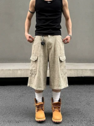 Stonewashed khaki wide-leg cargo long shorts front view styled with black tank top and work boots