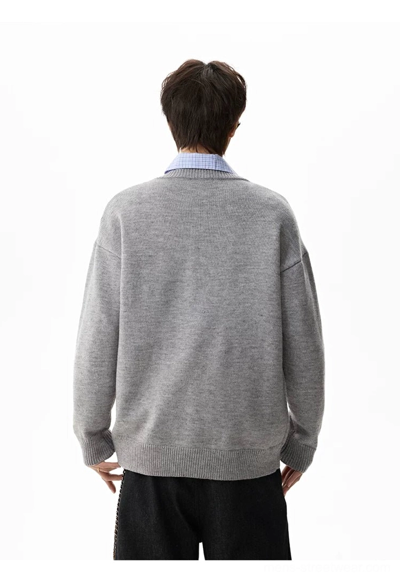 Streetwear henley sweater with dropped shoulders, loose sleeves, medium-weight knit construction, and layered outfit appeal