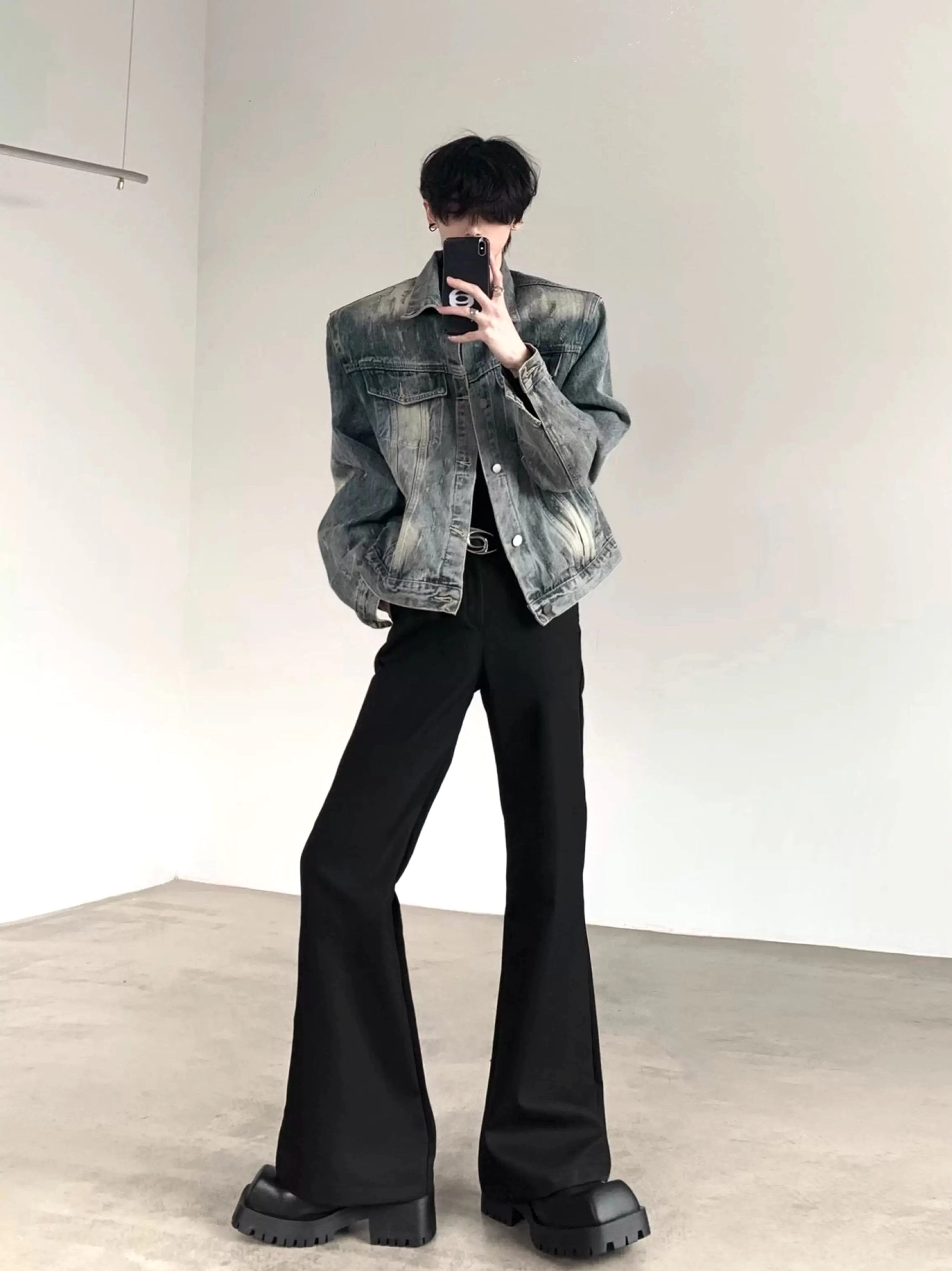 Structured washed blue denim shoulder pad jacket worn in a full body Korean streetwear inspired outfit with black flared pants