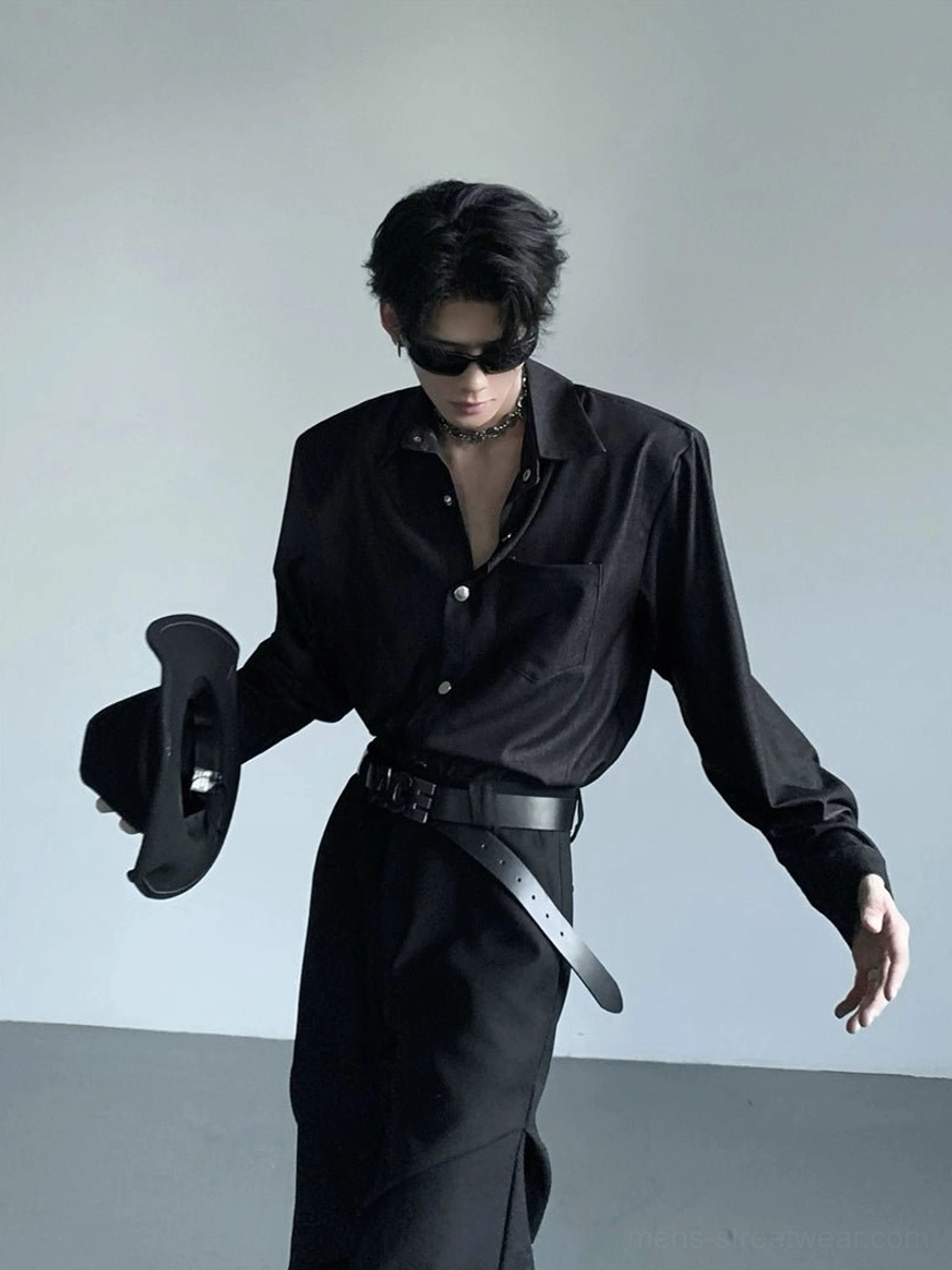Side three-quarter view of relaxed fit black wide shoulder button-up shirt with open collar and long sleeves