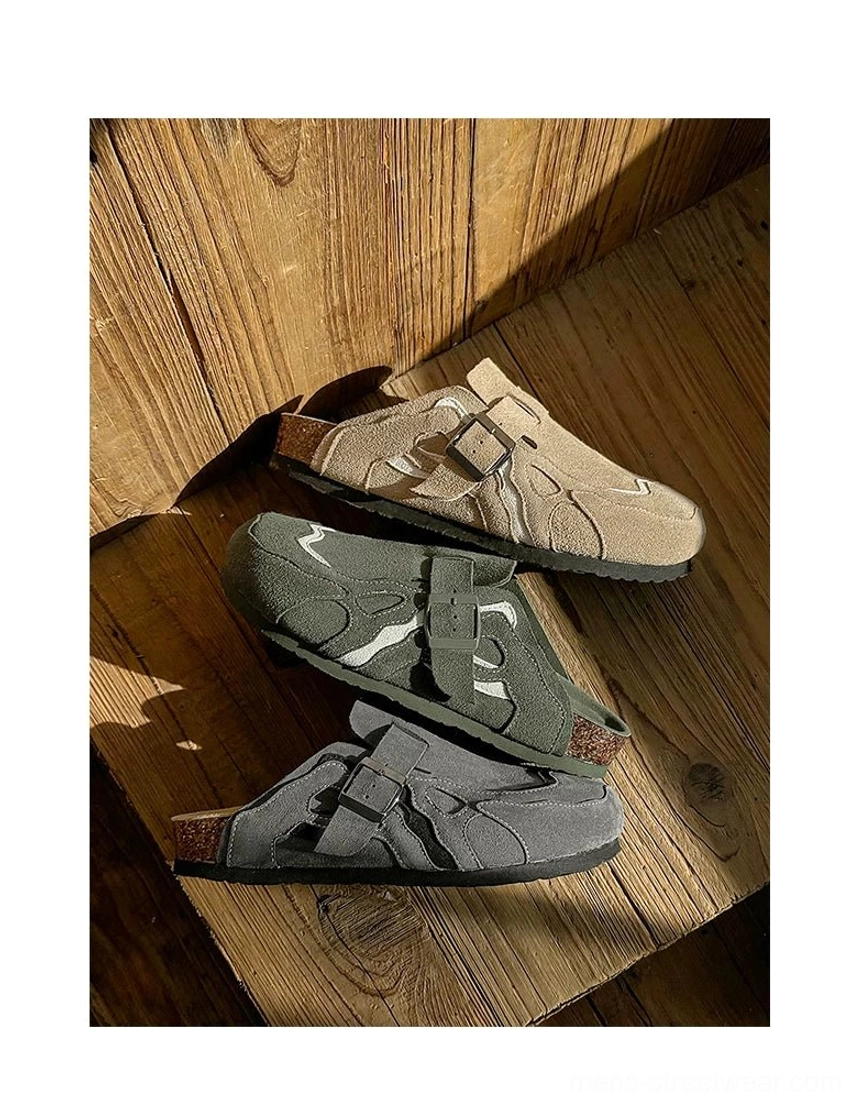 Three color options of suede buckle cork footbed clogs arranged on a sunlit wooden floor with classic round toe shape