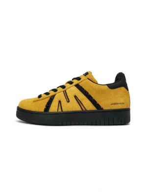 Mustard yellow suede platform skate sneakers with black side stripes, black heel accents, chunky rubber outsole, and low-top lace-up streetwear design