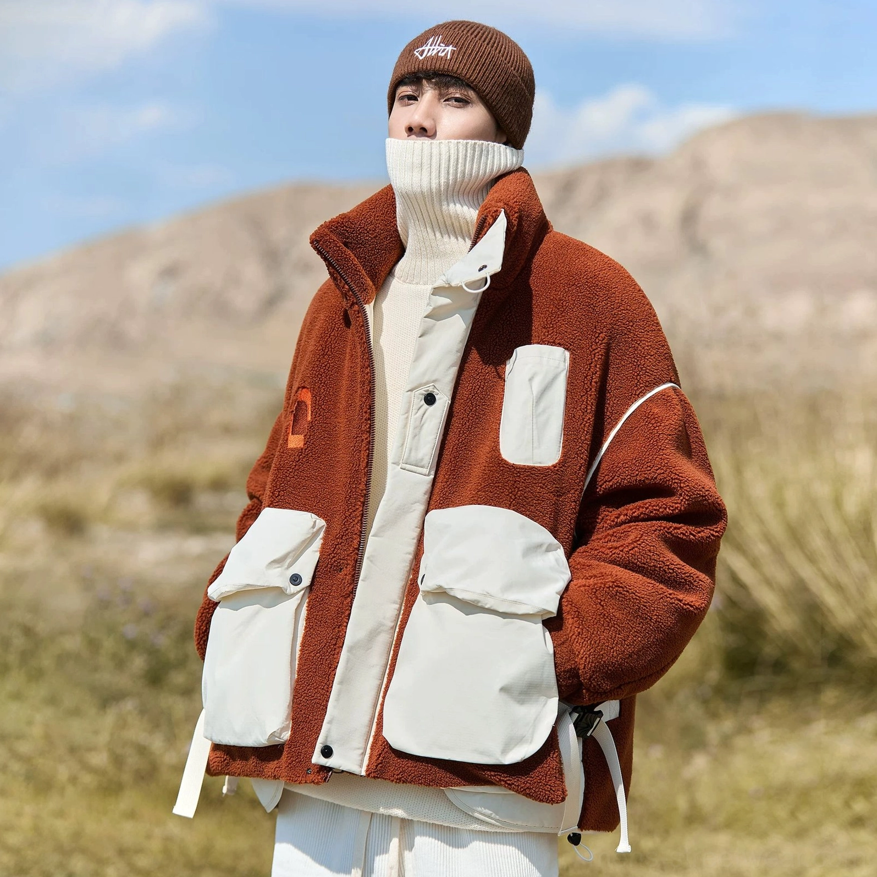 Sun Orange sherpa expedition jacket colorway with oversized outdoor streetwear proportions and insulated winter construction