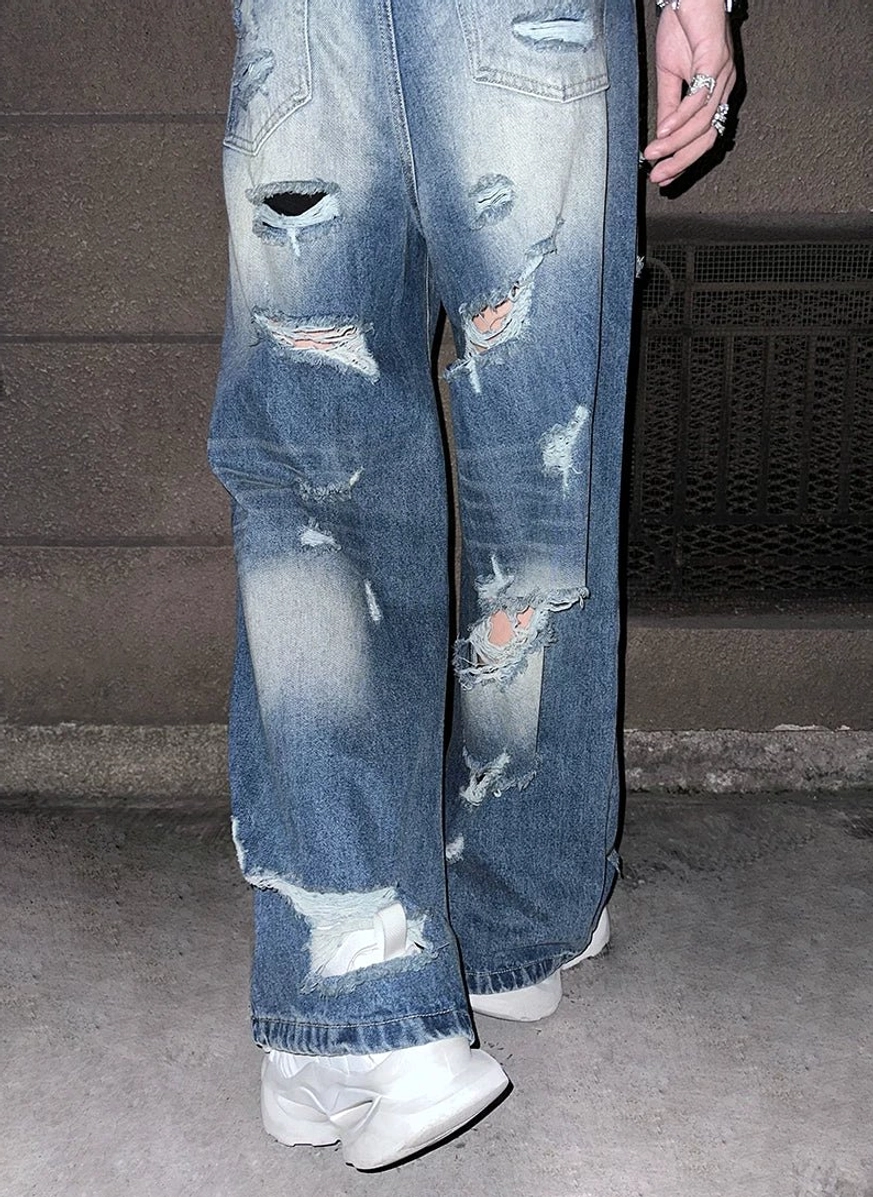 Super distressed wide-leg blue jeans featuring faded vintage wash and raw ripped denim details for Korean streetwear