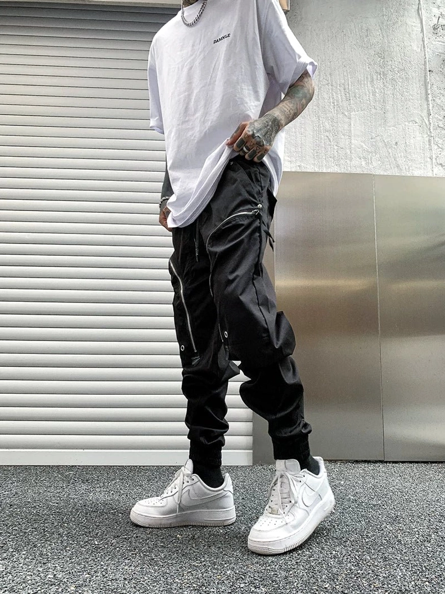 Tactical techwear cargo jogger pants with elastic drawstring waistband, zip pockets and tapered ankle profile