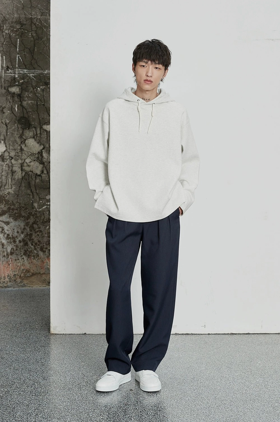 Tailored East Asian fashion trousers with double pleats and architectural wide-leg profile