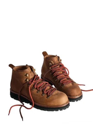 Tan brown heritage leather hiking boots with red hiking laces brass eyelets and rugged deep lug soles front three quarter view