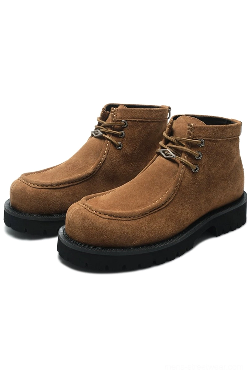 Tan brown shearling moc toe lug boots with chestnut cowhide upper, matching laces, and chunky black rubber lug outsole