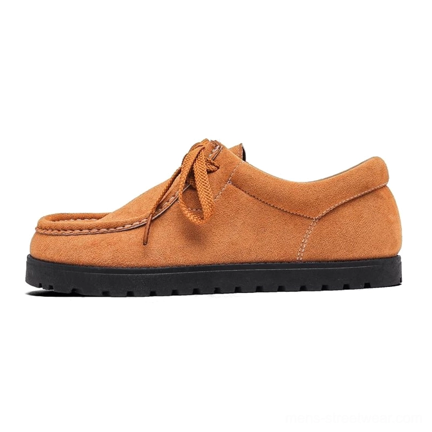 Tan brown suede square-toe lace-up shoes shown in side profile with tonal laces and contrasting black ridged rubber sole