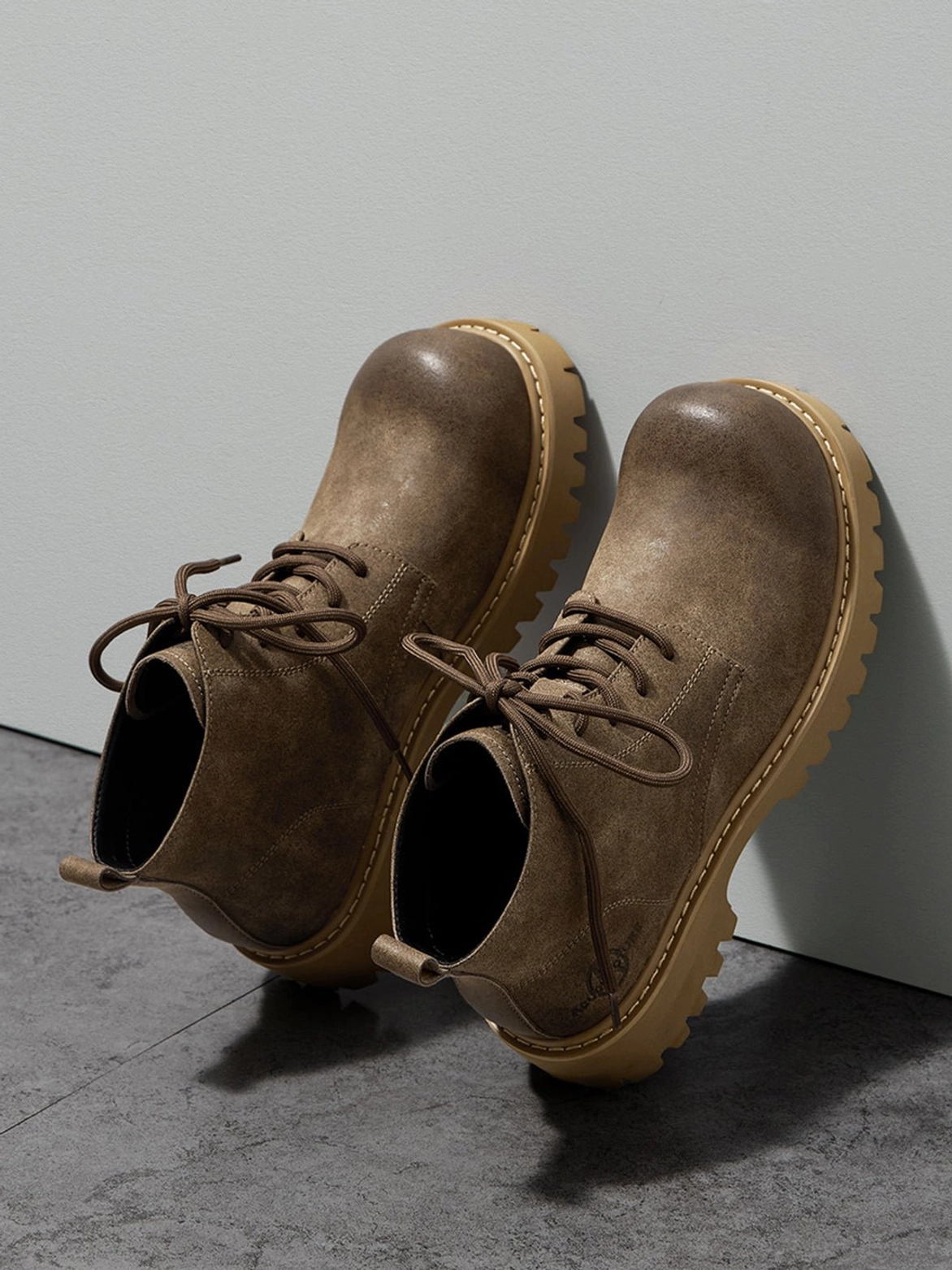 Tan chunky sole work boots with classic lace-up construction and modern Seoul streetwear appeal