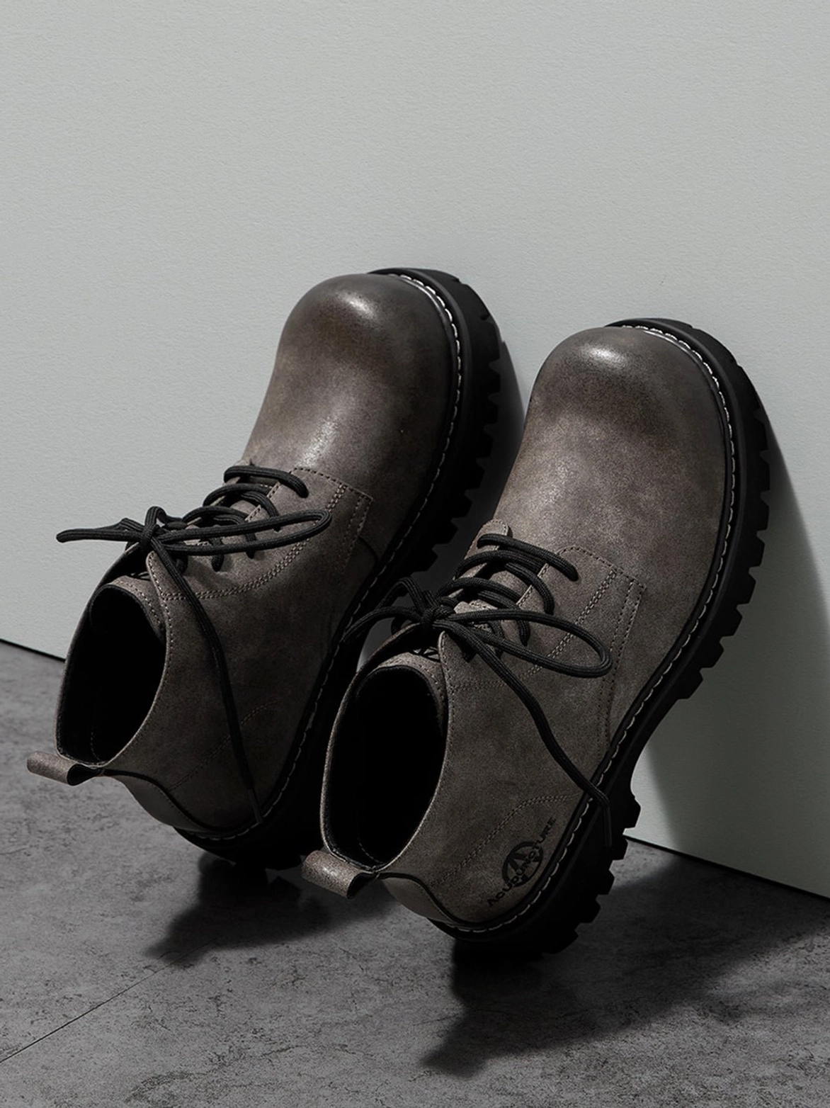 Tan chunky work boots with rounded toe and durable-looking tread for modern streetwear layering