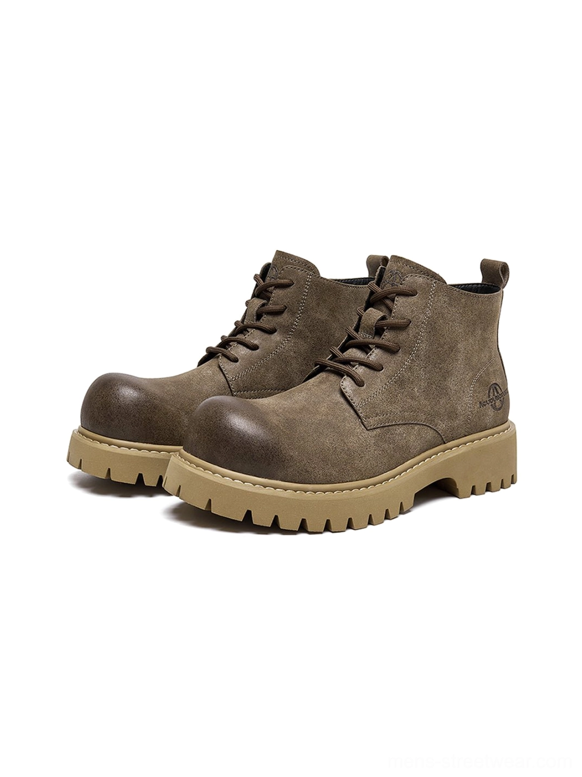 Tan distressed ankle boots with bold lug sole and relaxed round-toe shape for utility outfits