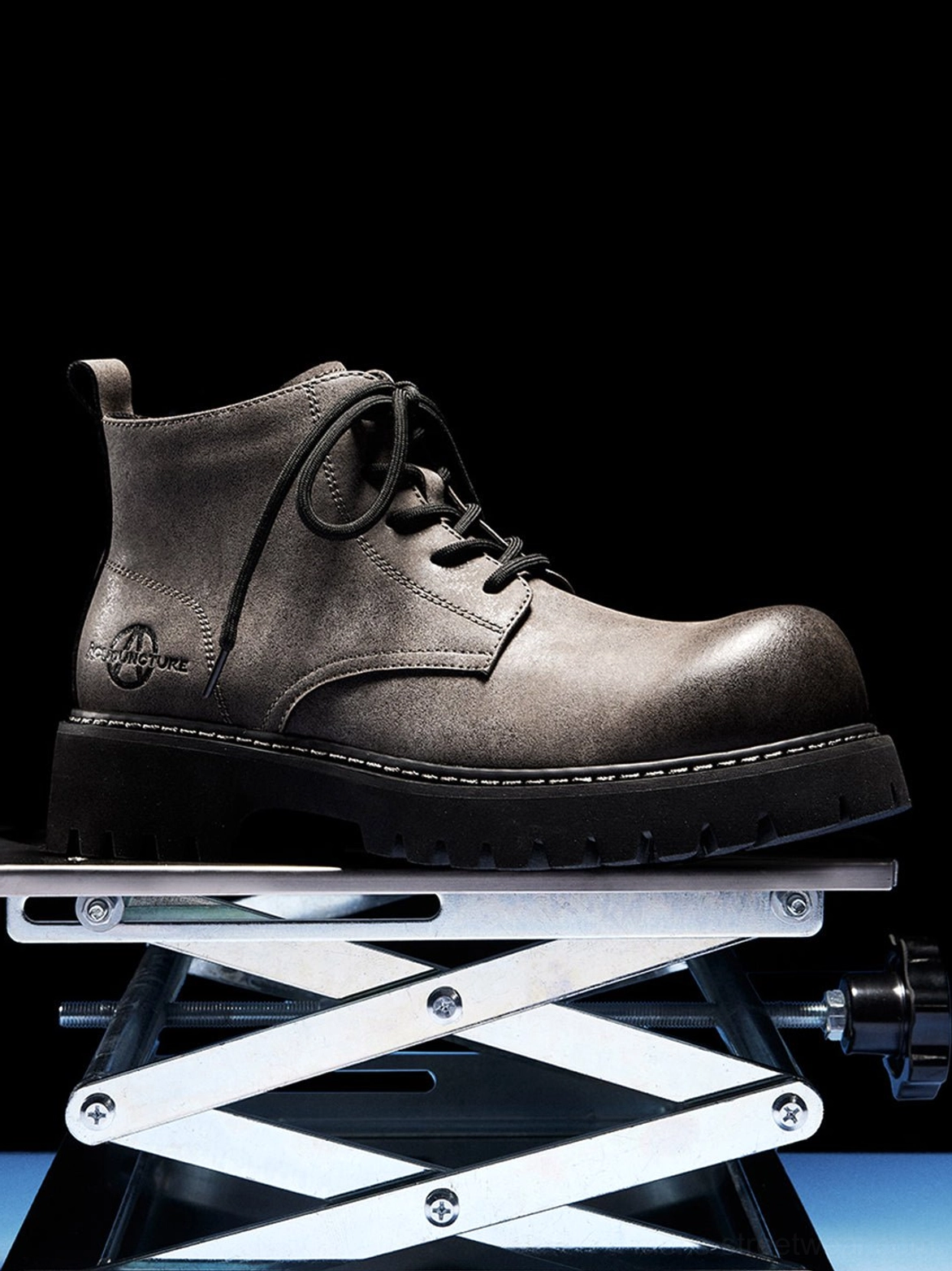 Tan distressed synthetic leather work boots with padded ankle collar and deep ridged sole