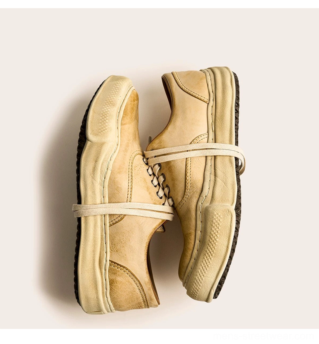 Pair of tan distressed washed leather sneakers shown from above with fabric binding straps, vintage thick soles, and retro East Asian streetwear design