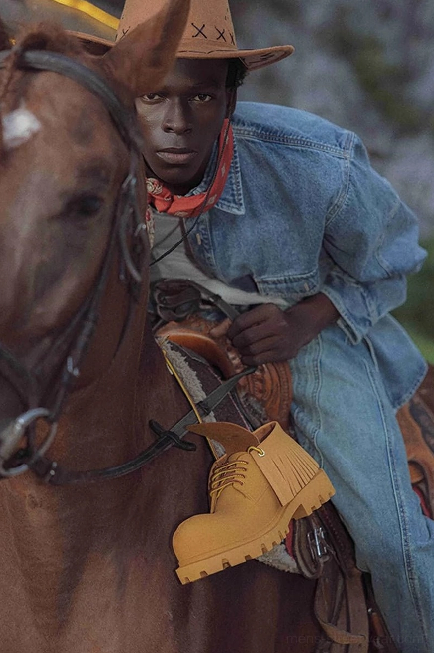 Tan fringe derby shoe styled on a Western horse saddle with denim clothing and cowboy hat for a rugged streetwear look