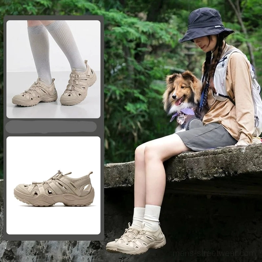 Tan khaki hybrid water hiking sandals worn with white socks in a green forest setting, showing breathable perforated upper and anti-slip rubber outsole