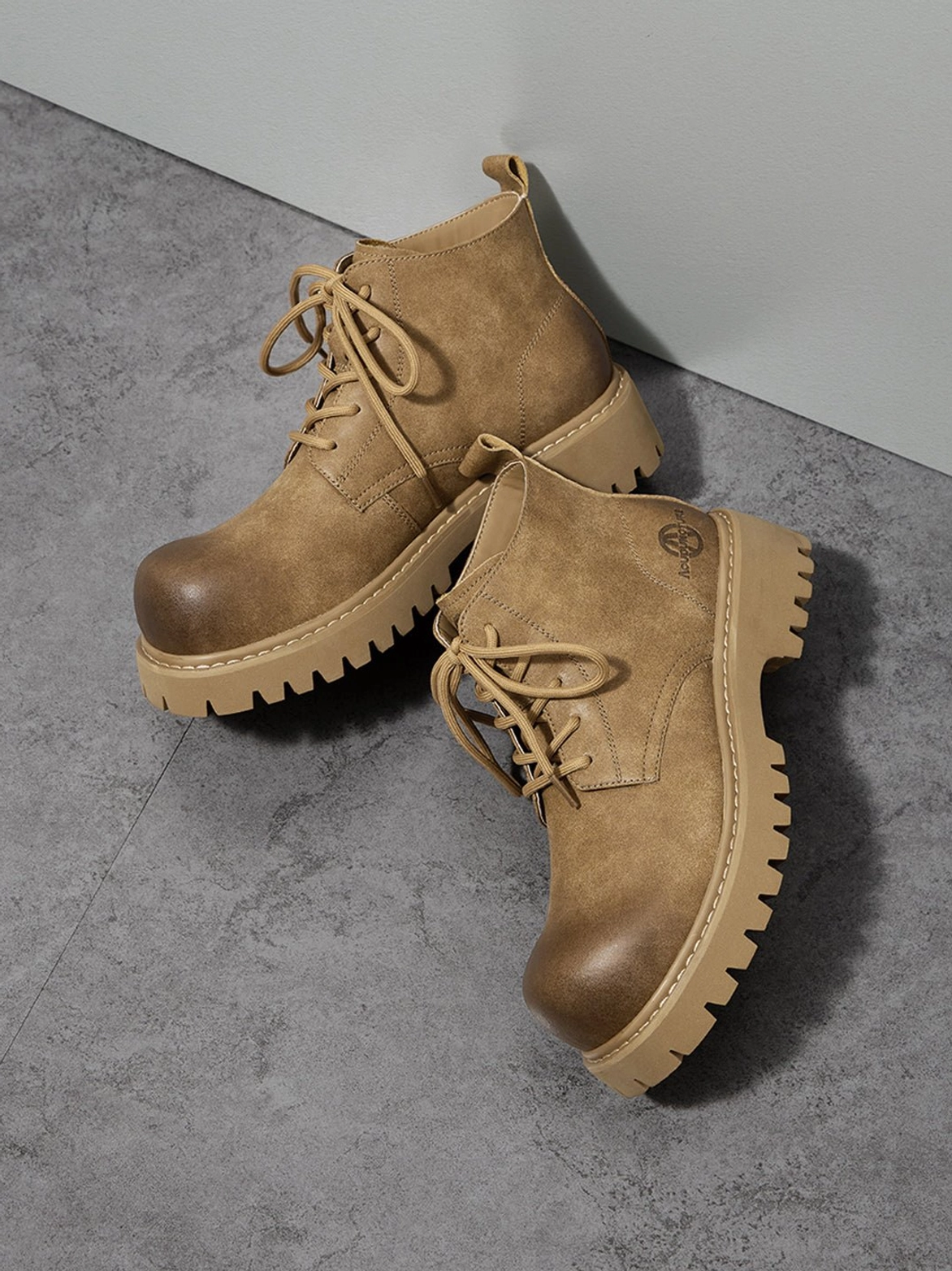 Tan Korean streetwear work boots with chunky tread and lace-up construction shown in a detailed product view