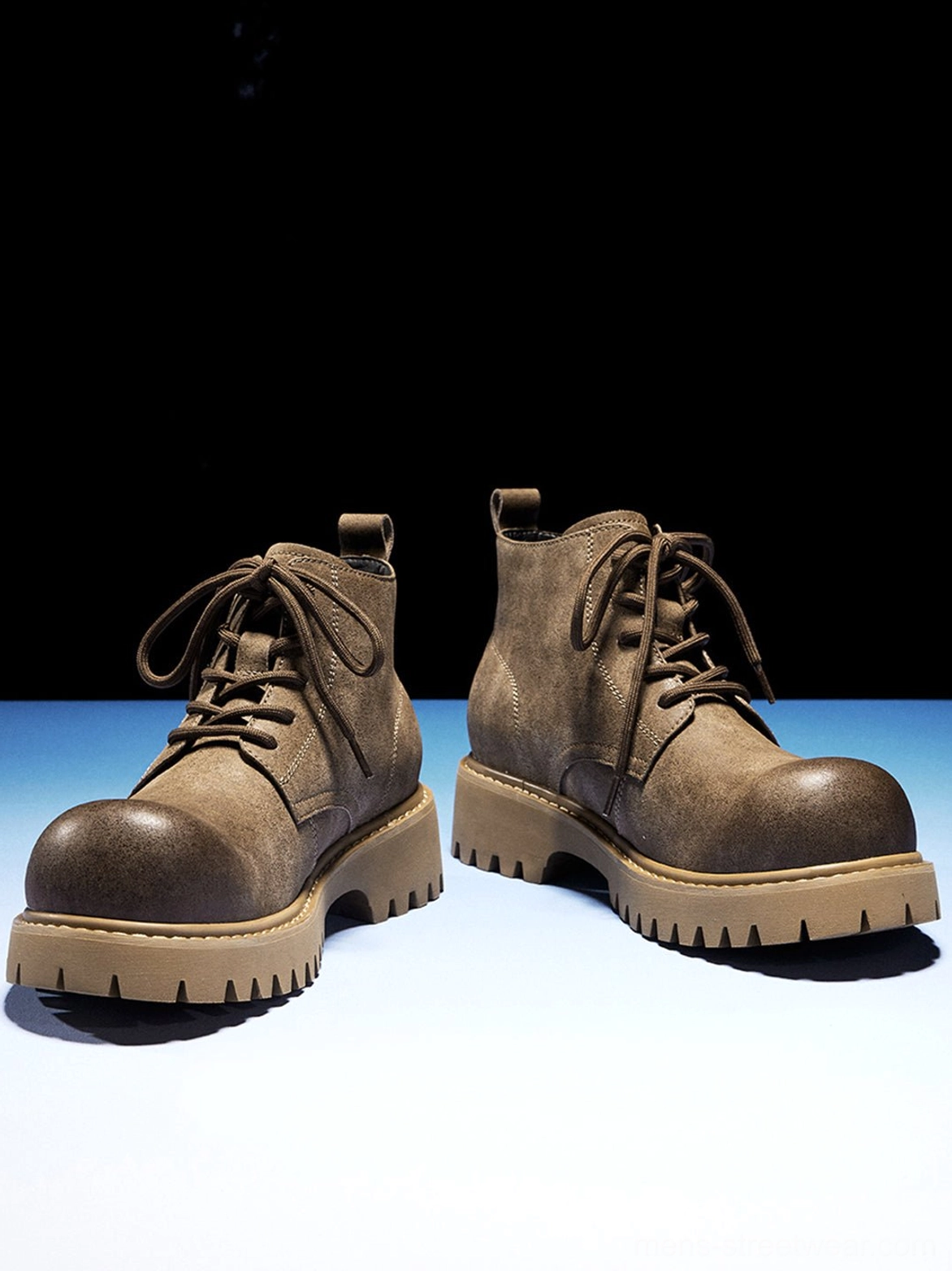 Tan lace-up lug boots with substantial profile for oversized denim, cargos, and wide-leg trousers