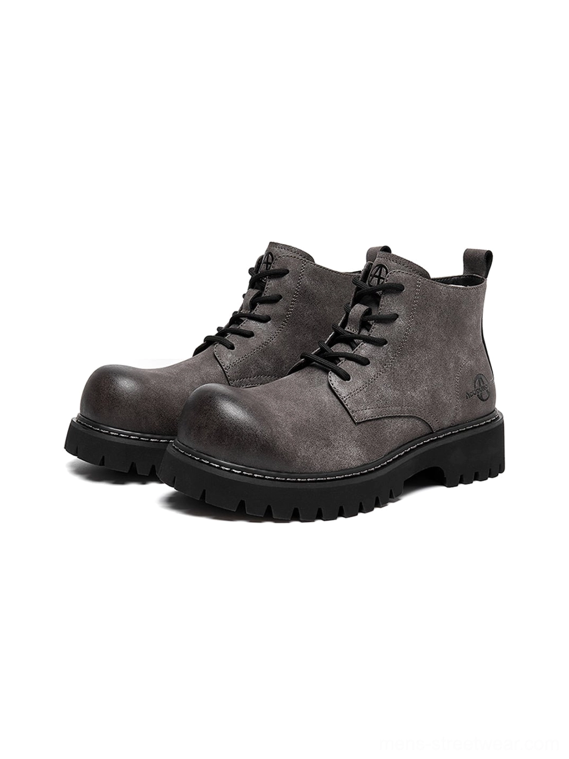 Tan lace-up utility boots with worn-in finish and strong outsole designed for everyday street style