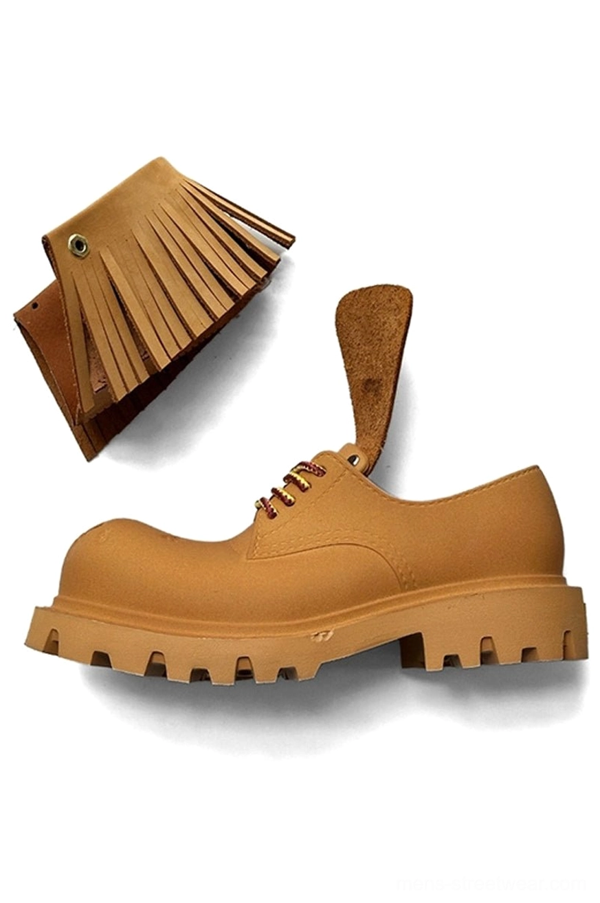 Single tan platform derby shoe with detachable fringe accessories and rugged EVA lug sole shown in a clean flat lay
