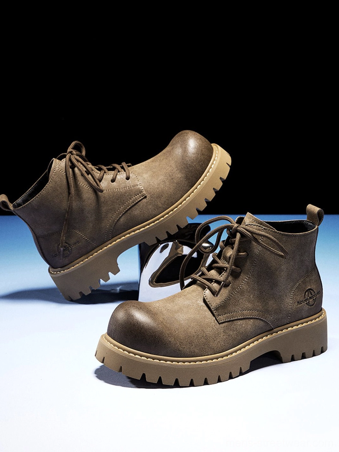 Tan round-toe streetwear boots with deep ridged outsole and understated distressed workwear aesthetic