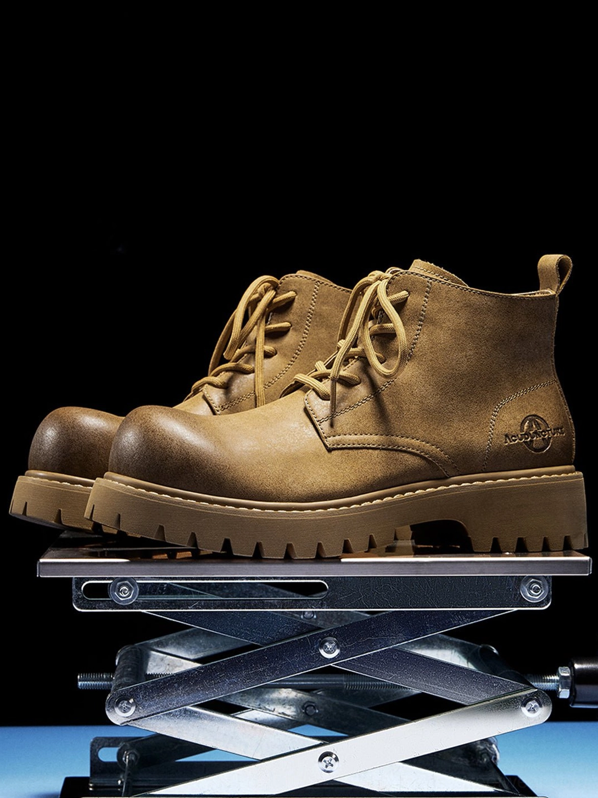 Tan streetwear work boots shown from the left three-quarter angle with detailed stitching and rugged lug outsole