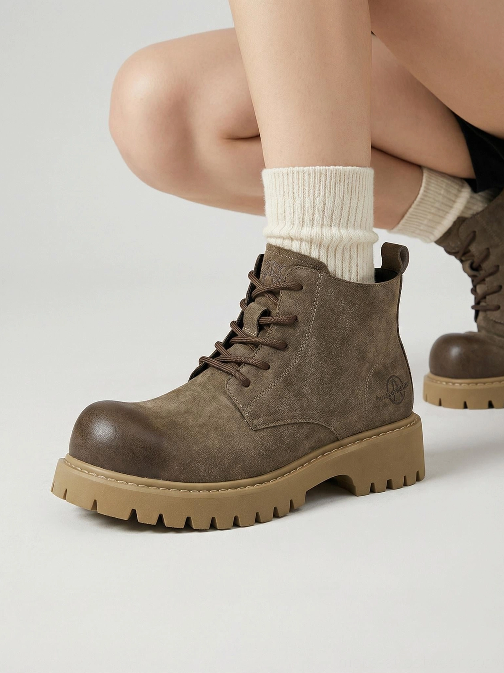 Tan utility lug-sole boots with rugged tread and relaxed silhouette for everyday urban styling
