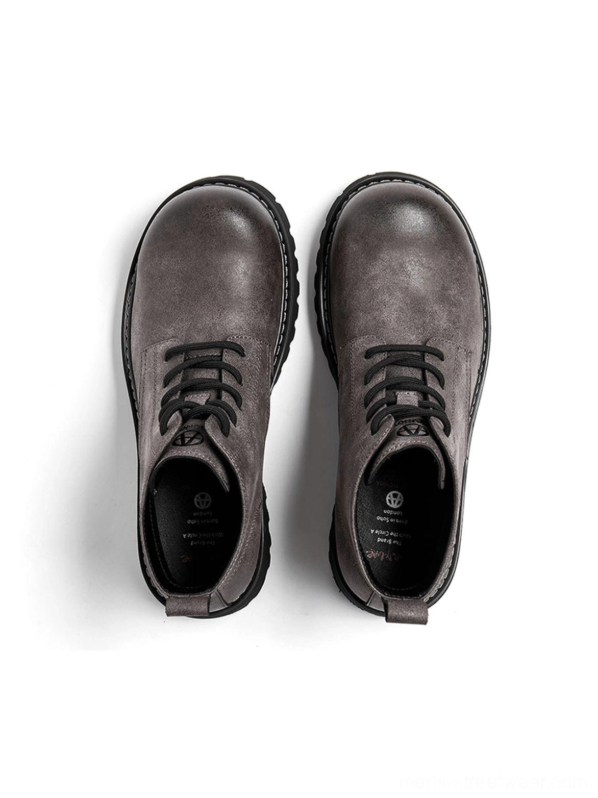 Tan workwear lug boots with substantial sole and versatile neutral color for casual urban outfits