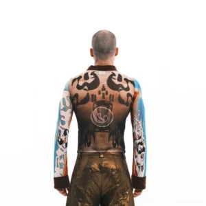 Back view of tattoo illusion sheer mesh long sleeve top showing full tattoo print, blue sleeves, and brown mock neck and cuffs