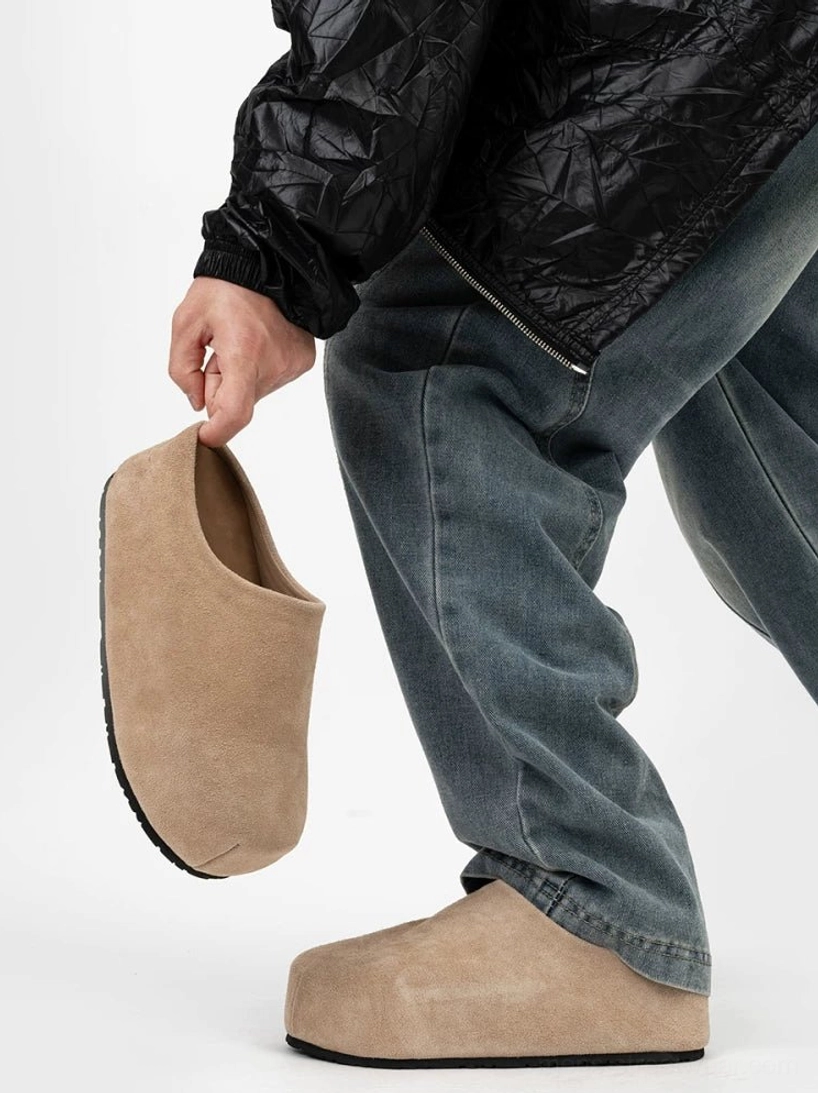 Taupe beige suede slip-on clog with a rounded box toe and thick flat platform sole styled with a casual streetwear outfit