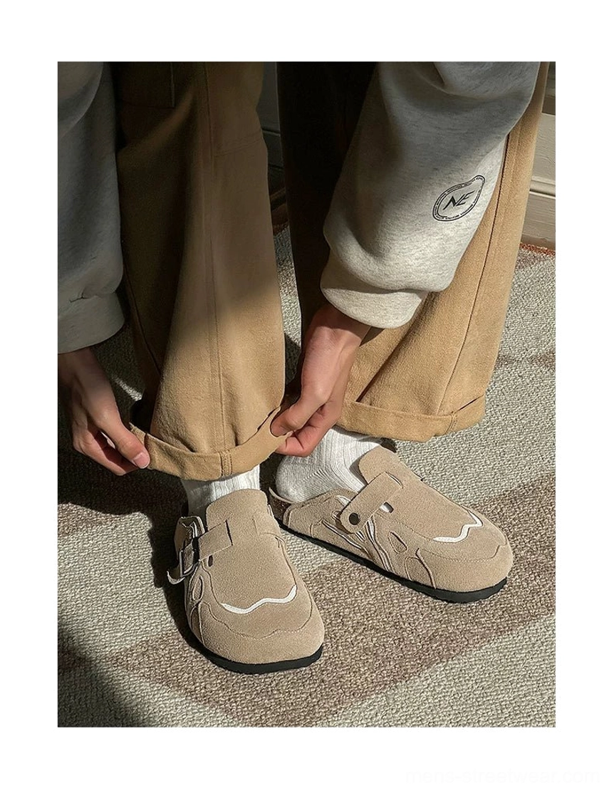 Top-down view of taupe beige suede slip-on clogs worn indoors with a contoured cork-look footbed