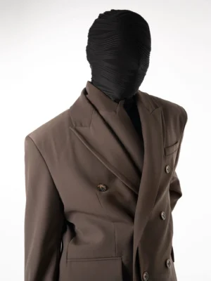 Close-up view of taupe brown double-breasted blazer with tailored lapels flap pockets and refined suiting fabric