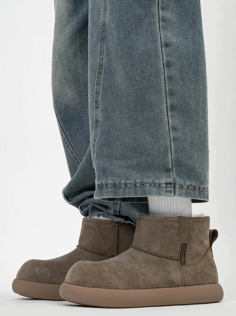 Taupe shearling ankle boots worn with rolled blue jeans and white socks, showing the warm fleece collar, clean silhouette, and matching platform sole