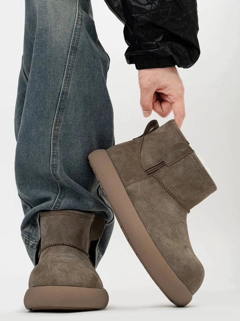 Taupe suede fleece-lined ankle boot held in hand to show its clean side profile, thick platform outsole, matte finish, and easy rear pull tab