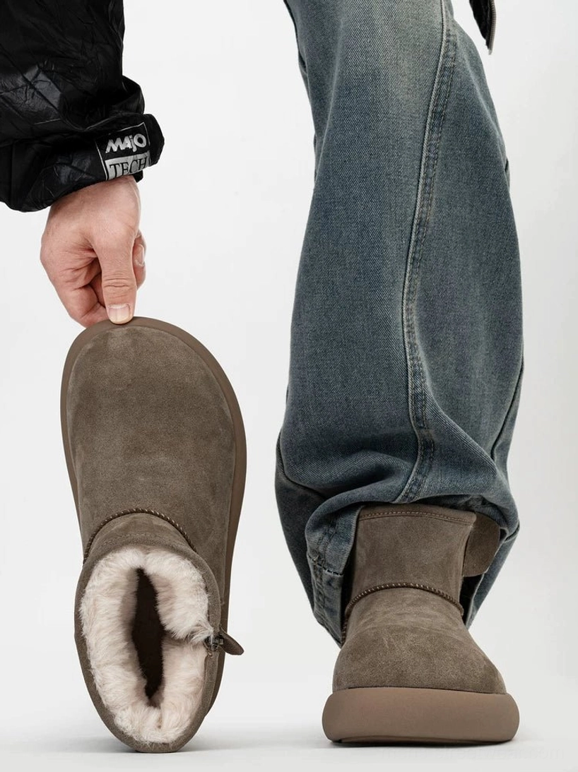 Taupe suede shearling ankle boots shown from the top and side on a male model wearing blue jeans, featuring warm fleece lining, a chunky platform sole, and a rear pull tab