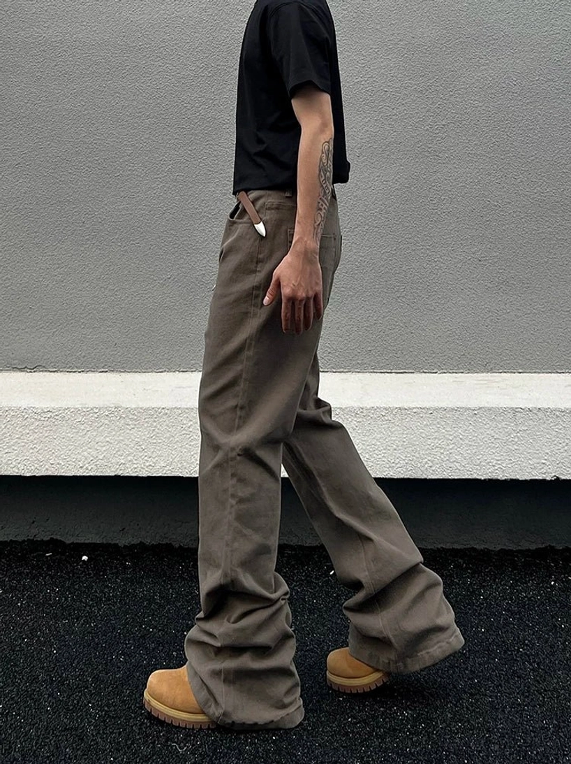 Side walking view of camel taupe washed straight-leg denim jeans with relaxed drape and long stacked hem