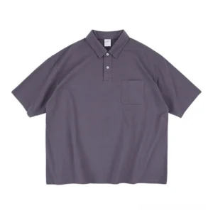 Front flat lay of a dark grey relaxed fit technical pocket polo shirt with knit collar, two button placket, short sleeves, and Korean streetwear styling