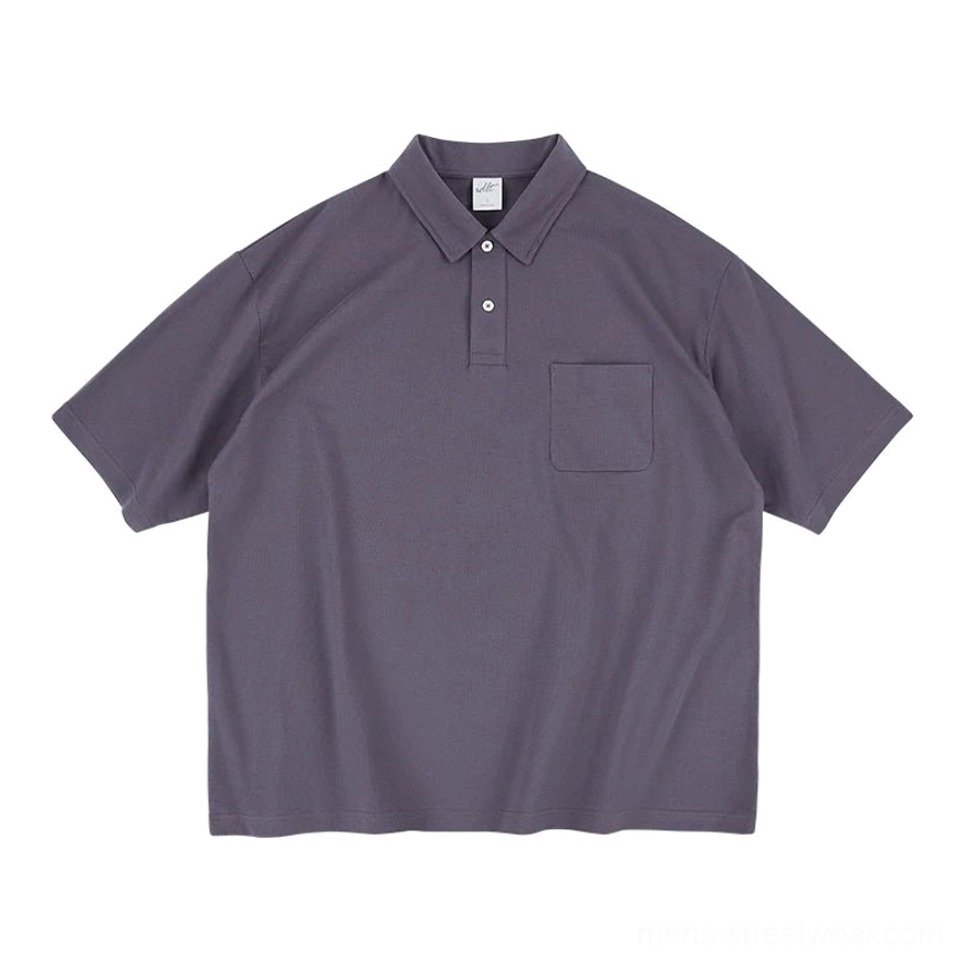 Front flat lay of a dark grey relaxed fit technical pocket polo shirt with knit collar, two button placket, short sleeves, and Korean streetwear styling