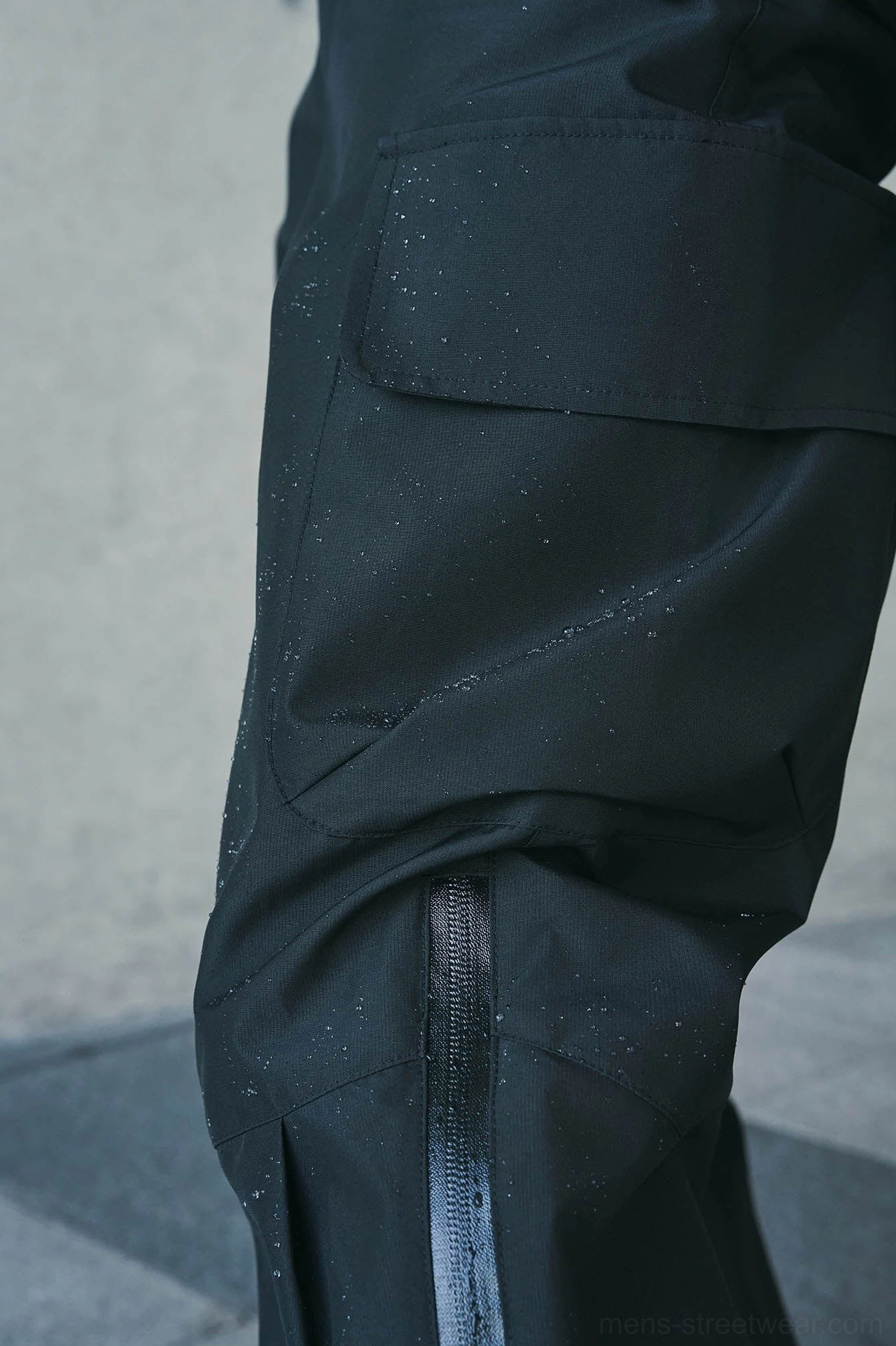 Techwear cargo pants product detail showing the smooth rain-resistant fabric and functional streetwear finish
