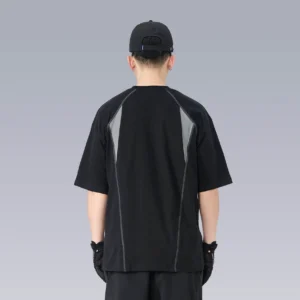 Back view of a loose techwear streetwear T-shirt showing the contrasting grey upper back panel, drop shoulders, and exposed seam details