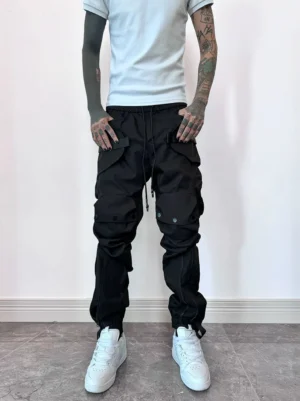 Black techwear zip cargo joggers front view with tactical cargo pockets, drawstring waist and tapered ankle cuffs