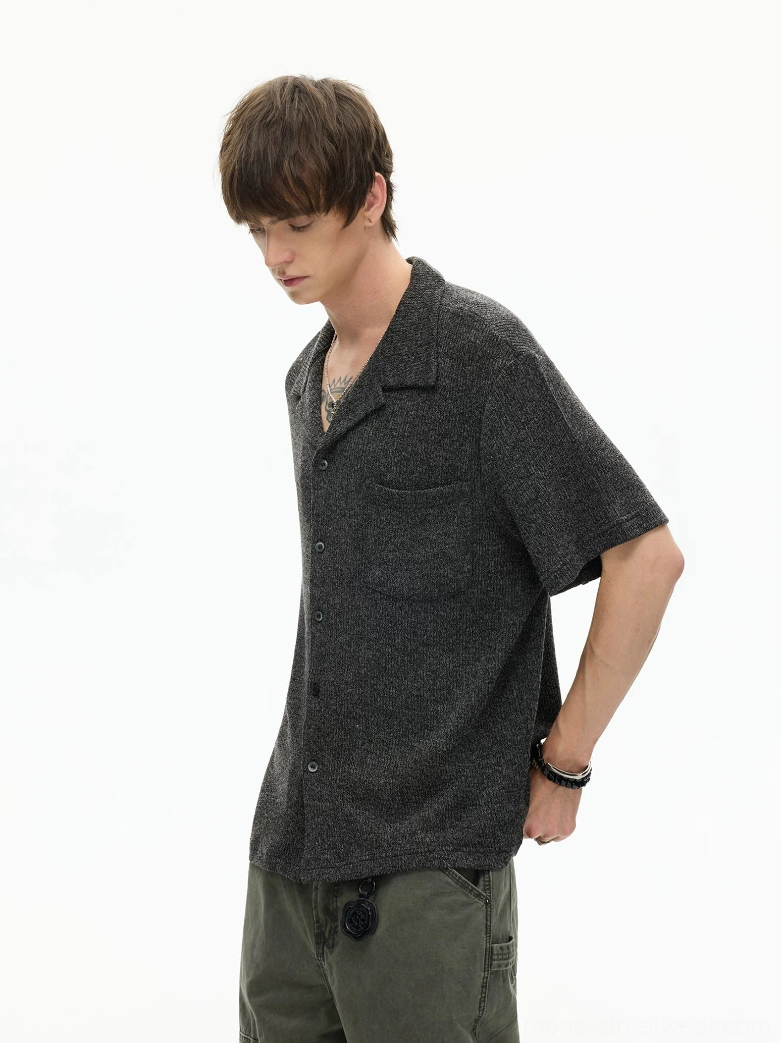 Textured camp collar shirt shown from the back with relaxed short sleeves and an easy streetwear silhouette styled with olive cargo pants