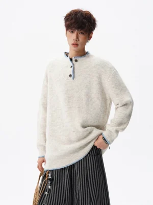 Off-white textured henley sweater with blue contrast trim styled with striped wide-leg trousers in a Korean streetwear outfit