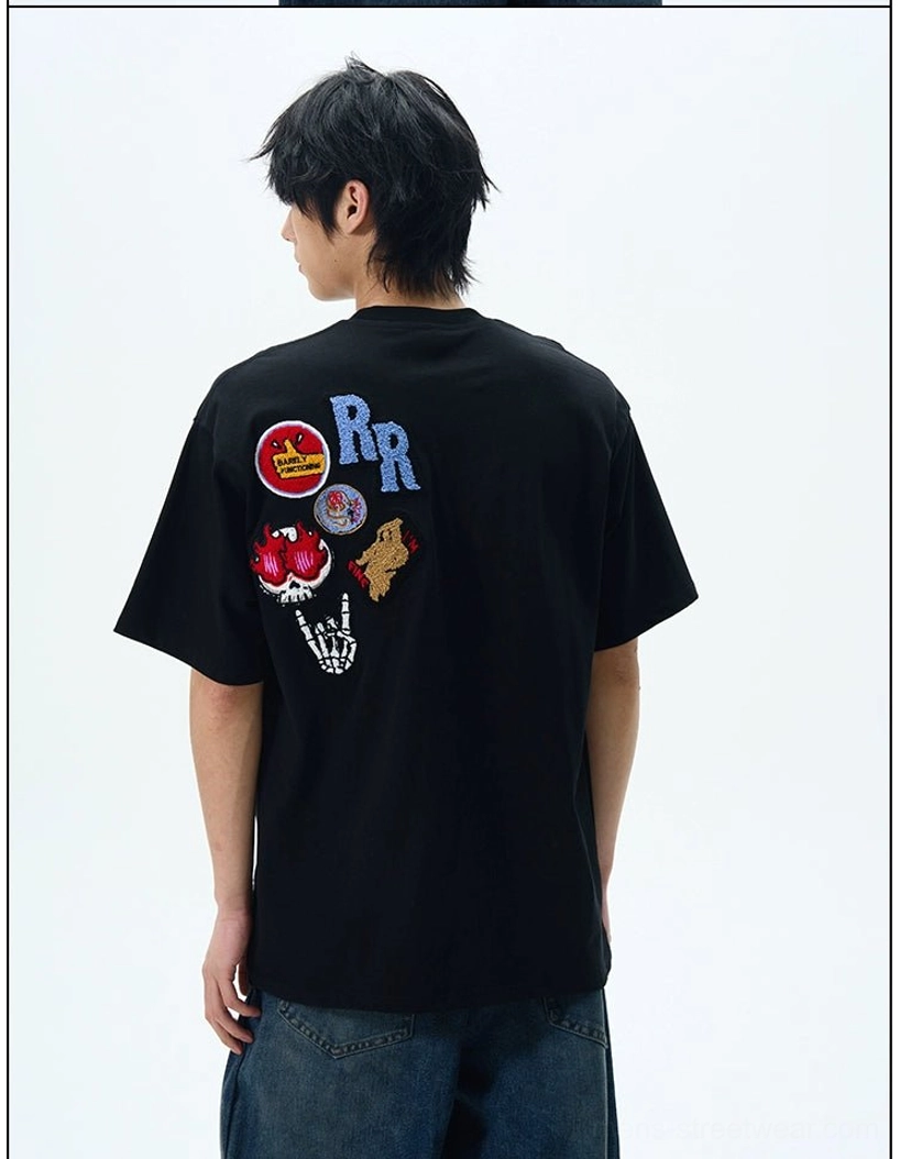 Rear view of black THE DOODS oversized streetwear T-shirt with colorful retro embroidered back patches