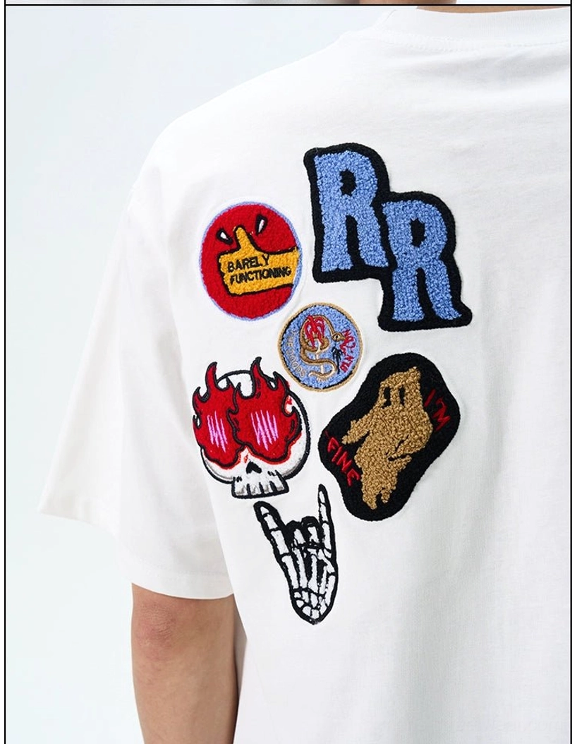 Close-up rear detail of white THE DOODS streetwear T-shirt with flame skull, skeleton hand, RR, and graffiti patches