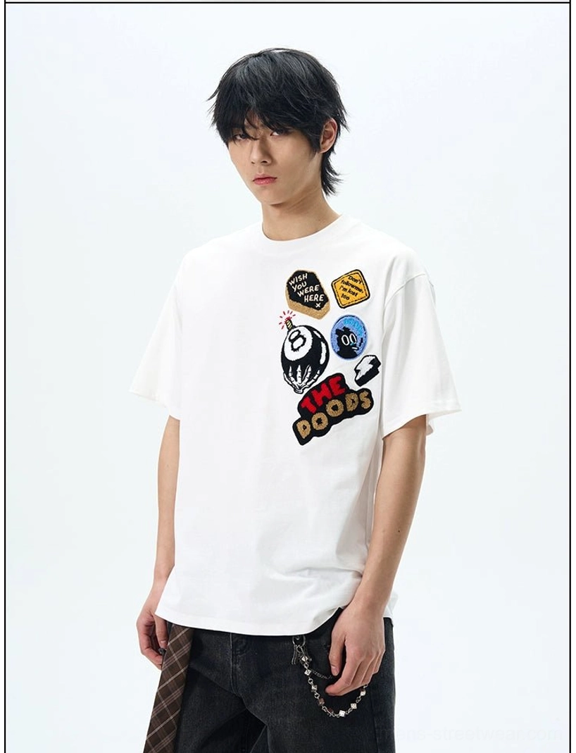White THE DOODS graffiti patch oversized T-shirt with colorful retro skate-inspired chest embroidery