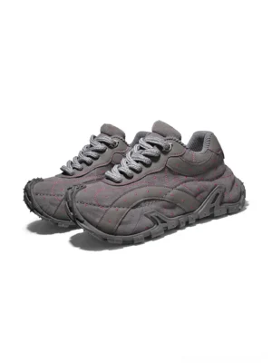 Pair of TrailGrid chunky streetwear sneakers in grey with padded ankle collars, thick round laces and outdoor-inspired construction