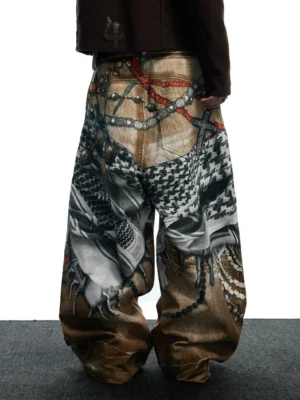 Rear low-angle view of relaxed tribal collage wide-leg jeans showing detailed chain bead and ornamental graphic prints across the back panels