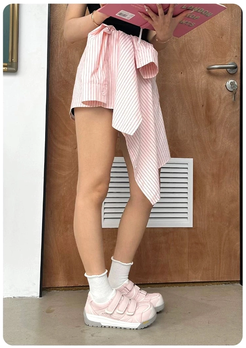 Full side view of pink Velcro platform sneakers paired with a coordinated striped wrap skirt outfit